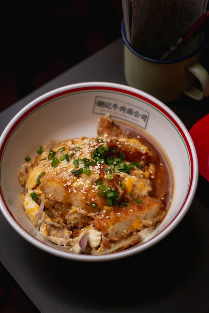 Teowkee egg-katsu rice bowl with sesame seeds and spring onion